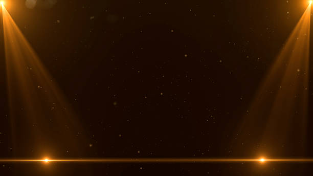 istock Golden stage spotlight beams with glowing particles and dark background, abstract award ceremony celebration light backdrop 2228635928