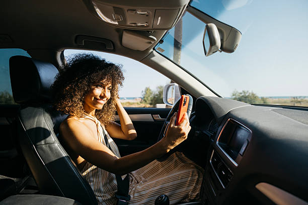 istock Young woman taking a selfie while driving on summer vacation 2228637006