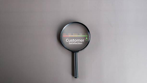 Magnifying glass focusing on customer satisfaction text with a colorful rating scale from worst to best. Concept of feedback, customer experience, and service evaluation.