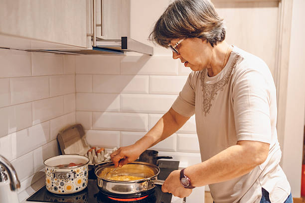 istock Woman cooking meal 2228638446