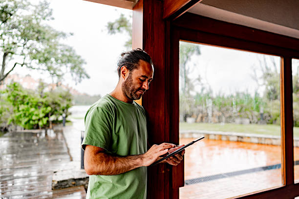 istock Mid adult man using digital tablet at home 2228638875