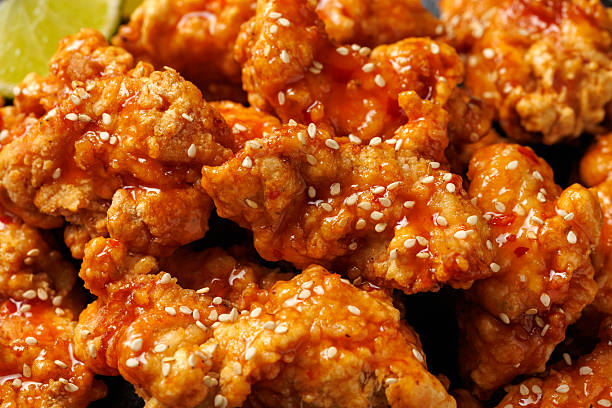 istock Korean fried chicken with spicy sauce and sesame seeds 2228639675