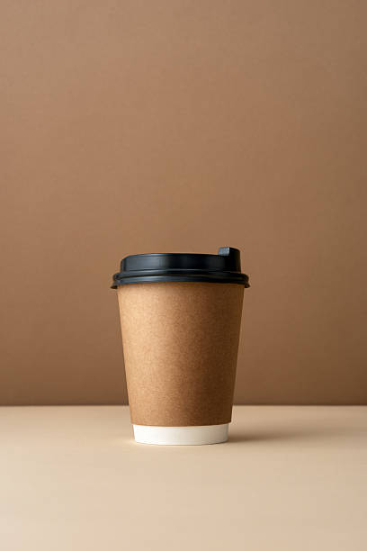 istock Paper coffee cup with black plastic lid on neutral background 2228640491