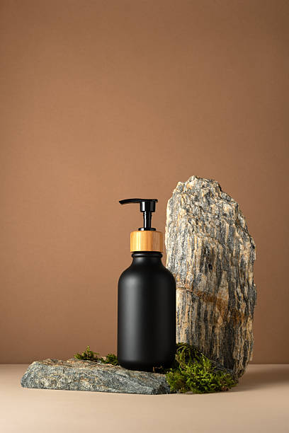 istock Minimal black cosmetic bottle mockup on stone podium 2228640526