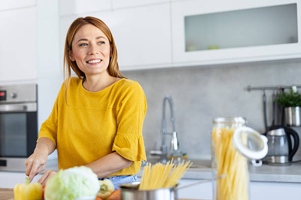 istock Culinary Moments: Woman Preparing Food with a Smile 2228640800