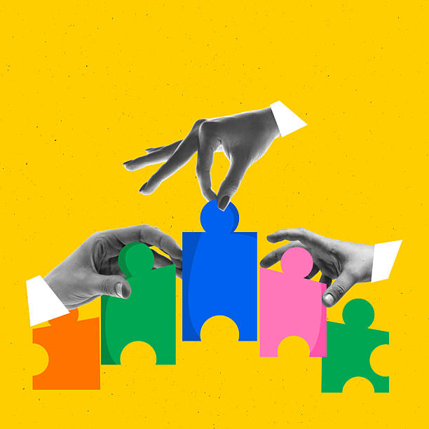 istock Stylized digital collage. Hands assembling colorful puzzle pieces on yellow background 2228641740