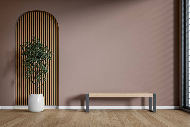 istock A minimalist interior space with a bench in front of a soft dusty rose (dark pink) wall and a potted plant in front of a wooden arched alcove, and windows 2228642320