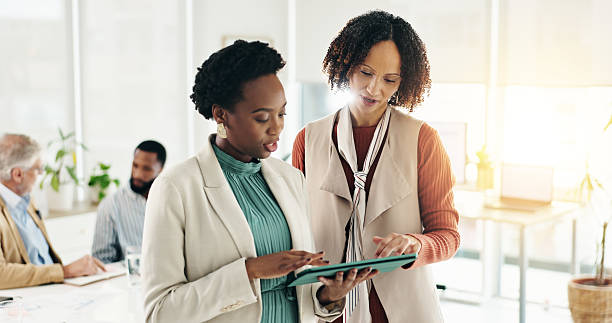 istock Team, tablet and business women planning project, help and feedback for insurance solution in office. Meeting, technology and manager with conversation for proposal, review or risk management policy 2228644416