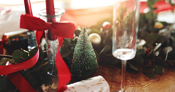 istock Christmas, decorations and champagne glass on table in dining room for festive celebration, event or lunch. Holidays, place setting and tree for xmas with social gathering in December in home. 2228645143