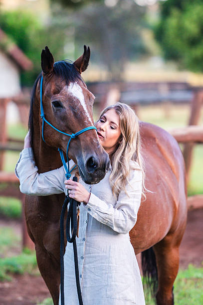 istock Woman Connecting with a Horse in a Pastoral Setting 2228646105