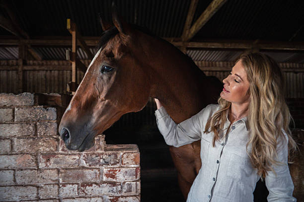 istock Woman bonding with her horse in stable setting. 2228646243