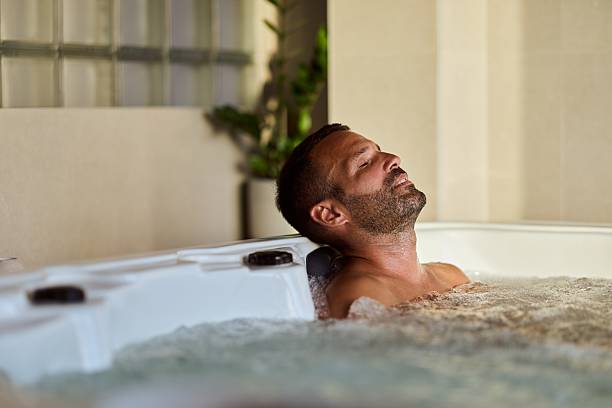 istock Man Relaxing in a Hot Tub Enjoying a Serene Spa Experience 2228646866