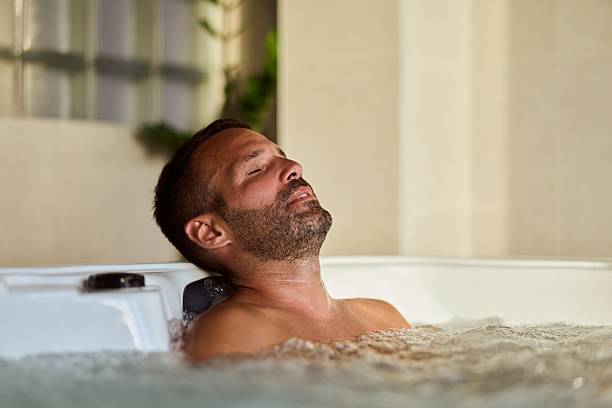 istock Man Relaxing in a hot tub Enjoying a Tranquil Luxury Spa Experience 2228646869