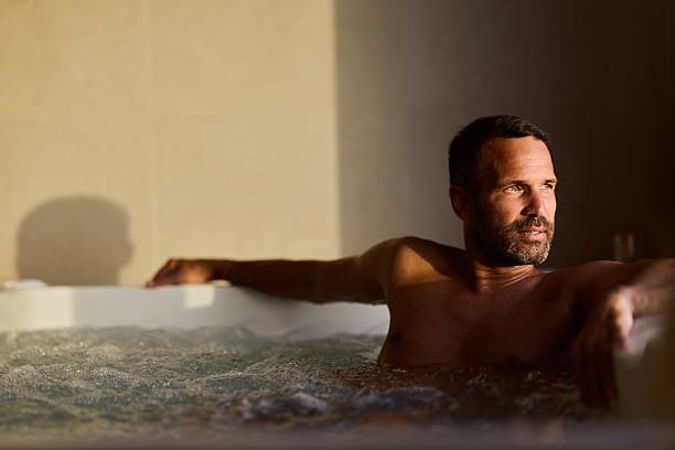 istock Relaxed Man Enjoying a hot tub With Sunlight on His Relaxed Face 2228646891