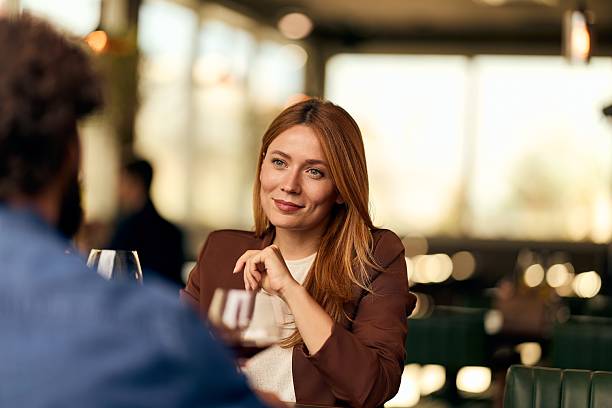 istock Woman Smiling During Conversation in a Cozy Restaurant Setting 2228646905