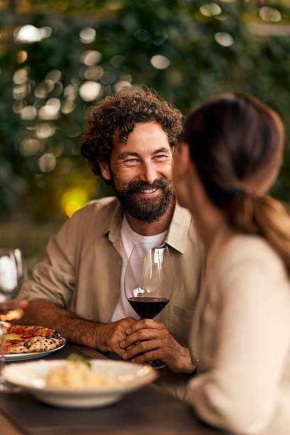 istock Couple Enjoying a Romantic Dinner Outdoors With Wine and Intimate Conversation 2228646922