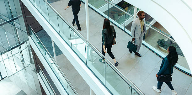 istock Businesspeople walking through modern office building interior 2228647280