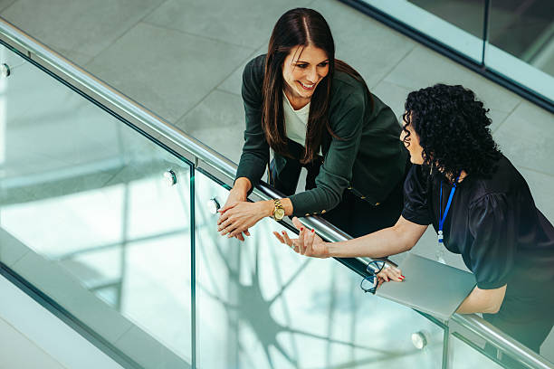 istock Casual conversation between female corporate employees indoors 2228647412