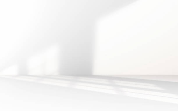 istock Minimalist abstract empty white room for product presentation, light beam falling into the room from the window 2228648420