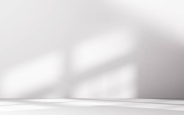 istock Minimalist abstract empty white room for product presentation, light beam falling into the room from the window 2228648501