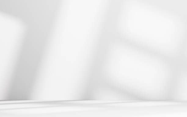 istock Minimalist abstract empty white room for product presentation, light beam falling into the room from the window 2228648528