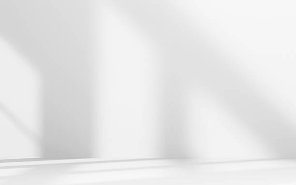 istock Minimalist abstract empty white room for product presentation, light beam falling into the room from the window 2228648544