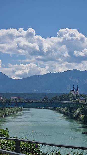 istock River View with Church and Mountains under a Blue Sky in Austria 2228650790
