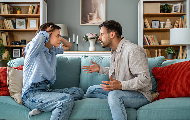 istock Young couple arguing loudly at home on sofa 2228654608