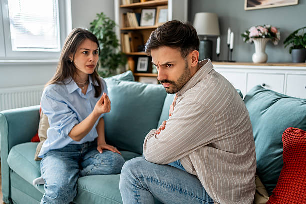 istock Young couple arguing on sofa at home living room 2228654645
