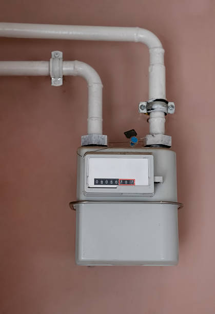 istock Utility meter installed on a wall with white piping for measuring gas or water consumption in a residential setting 2228655142