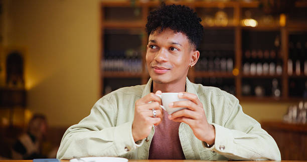 istock Man, tea and happy with thinking at cafe for memory, drink and insight with inspiration at restaurant. Person, smile and coffee cup with reflection, remember and perspective with beverage at diner 2228656192