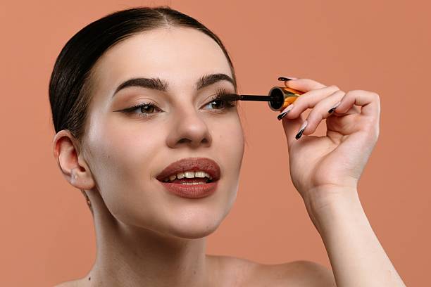 istock Young Woman Applying Mascara for Enhanced Eyelash Look 2228656573