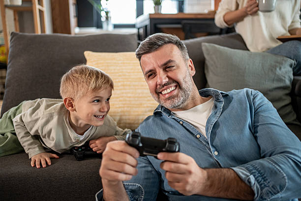 istock Father and son having fun playing video games at home 2228656663
