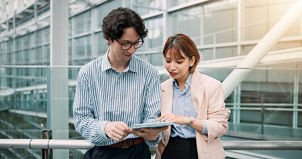 istock Tablet, research and people in office for collaboration, teamwork and planning together for project. Digital technology, partnership and financial advisors work on finance investment report in Japan. 2228656900