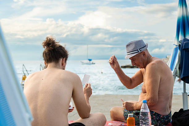 Grandson who loves to hang out with his granddad playing cards at the beach