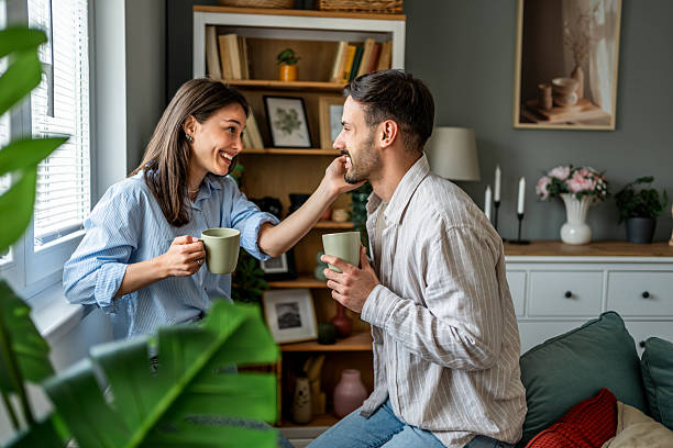 istock Young couple sharing a tender moment while drinking coffee at home 2228658691