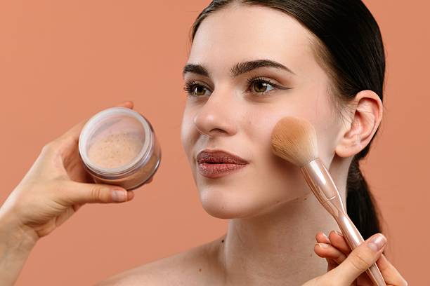 istock Woman Applying Loose Face Powder Using Soft Makeup Brush 2228658869
