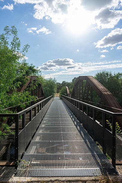 istock Old iron railway bridge repurposed for crossing a stream on an ecotrail. 2228658905