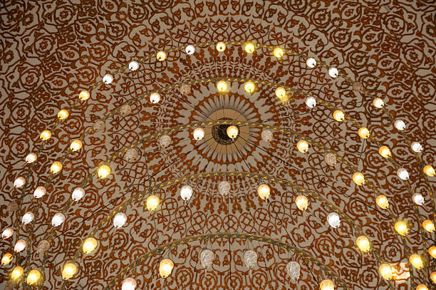 istock Ornate mosque ceiling glows with symmetrical Islamic lights 2228659863