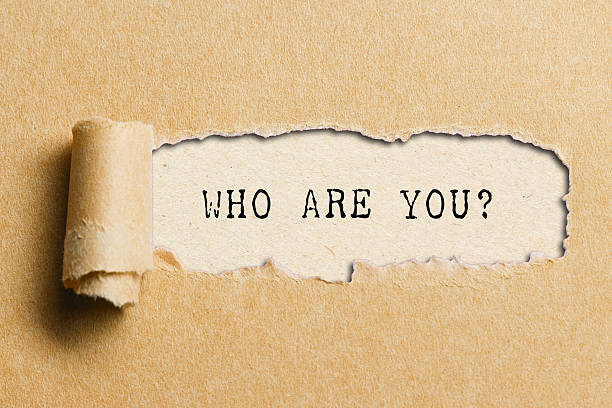 istock Who are you? Question written under torn paper. 2228660171