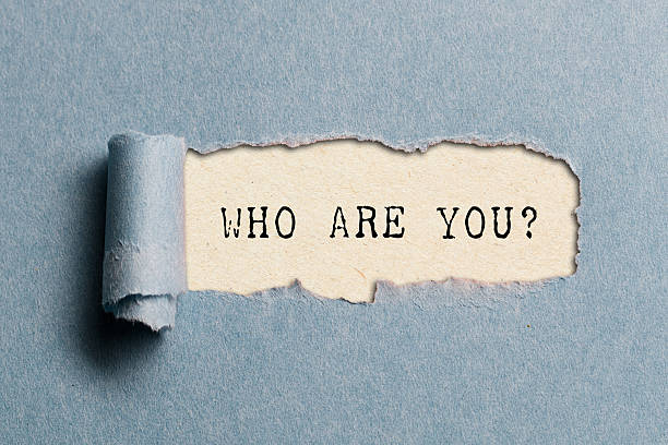 istock Who are you? Question written under torn paper. 2228660173