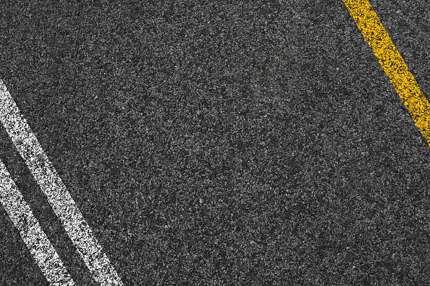 istock Double Yellow Line On New Asphalt Road texture background 2228660293