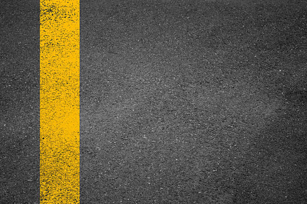 istock Double Yellow Line On New Asphalt Road texture background 2228660294