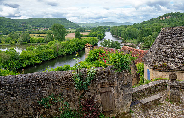 view from a hill over the landscape with the dordogne river in the village of beynac in the region of perigord, france