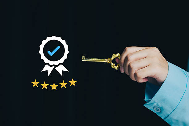 istock Hand Holding Golden Key with Badge and Stars for Security 2228660628