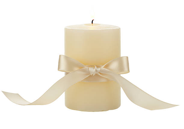 istock Isolated Elegant Cream-Colored Candle Adorned with a Silk Bow 2228662184