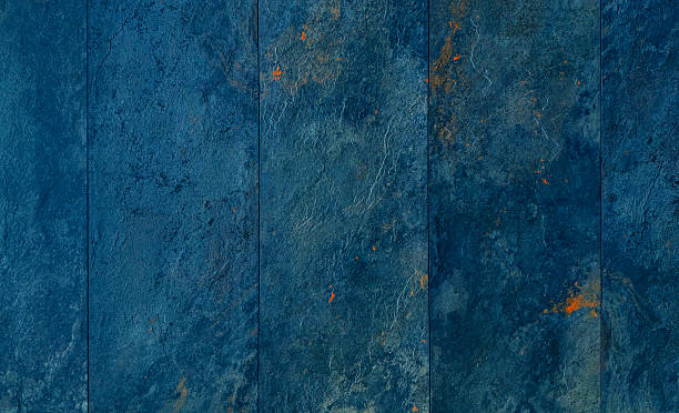 istock Weathered natural blue stone texture background with rust-colored accents. Dark blue and navy tones create a raw, industrial feel. 2228662871