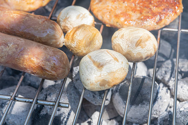 A close-up shot of roasted potatoes and tomatoes with garlic, freshly baked in the oven on a tray. The golden, seasoned potato wedges are paired with sweet, roasted cherry tomatoes, garnished with black pepper, and the garlic cloves, giving off a warm, savory aroma. Perfect for a healthy, easy-to-make side dish.