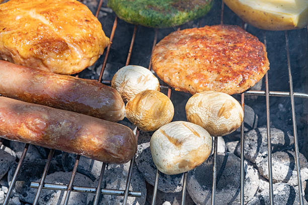 Barbecue meal. Hamburguers, mushrooms, hot dogs, potatoes and hot dogs buns. Perfect for a summer garden party.Green chicken burger with spinachs