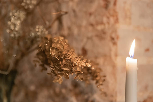 istock Burning candle and golden dried flowers 2228667334